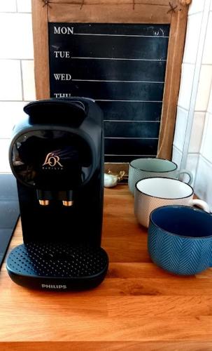 a black coffee maker sitting on a wooden table at Waterville Links in Waterville