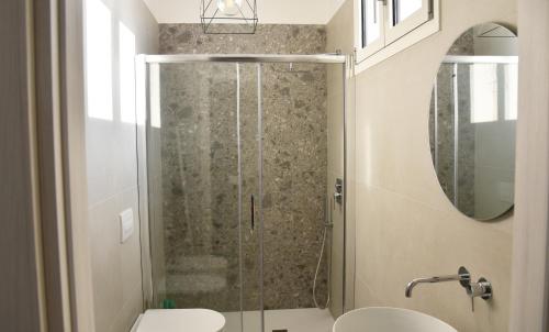 a bathroom with a shower with a toilet and a sink at Olga Suite in San Pietro Vernotico