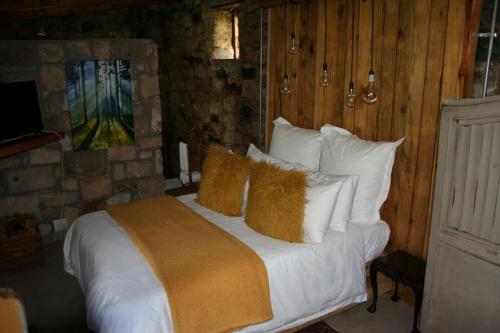 a bedroom with a bed with white sheets and pillows at John Jack Inn Accommodation in Chrissiesmeer