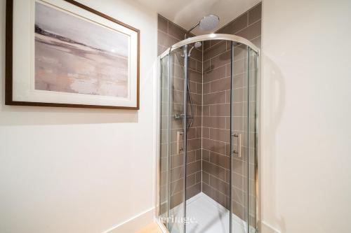 a shower with a glass door in a bathroom at The Old Sorting Office, Aboyne, Royal Deeside in Aberdeen
