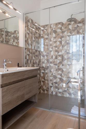 a bathroom with a sink and a shower at NONNU NONNA in Padru