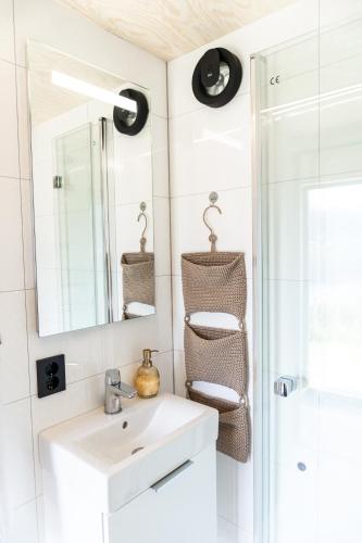 a bathroom with a sink and a mirror at Cabin in the orchard in Sandane