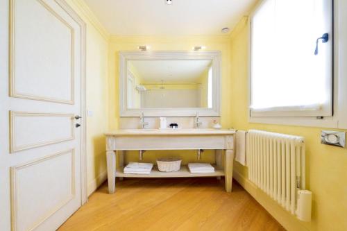 a bathroom with a sink and a mirror at Siri Hotel in Fano
