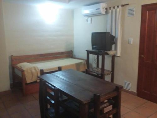 a small room with a bed and a television at Cabañas Santa Catalina in Tilcara