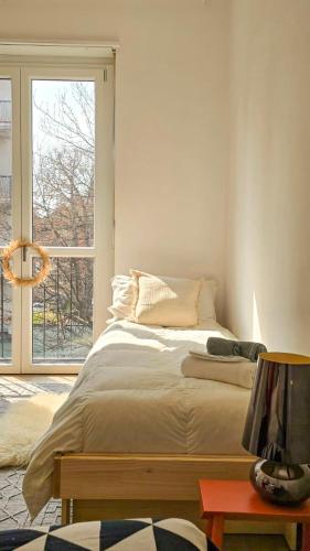 a bedroom with a bed and a large window at Suite and Home between Milano, Malpensa e Como Lake in Saronno