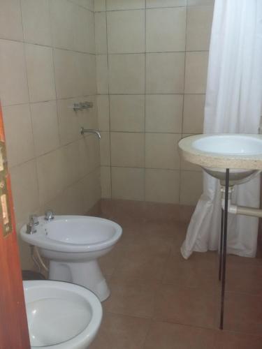 a bathroom with a toilet and a sink at Cabañas Santa Catalina in Tilcara