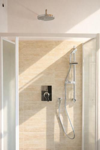 a shower in a bathroom with a glass wall at Hotel Favorita Easy Stay B&B in Cesenatico