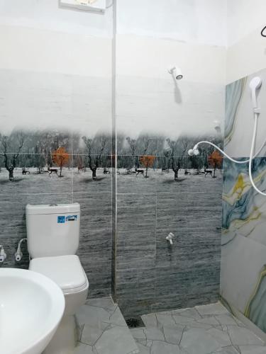a bathroom with a toilet and a sink and a shower at Duncan Murray Villa in Hambantota