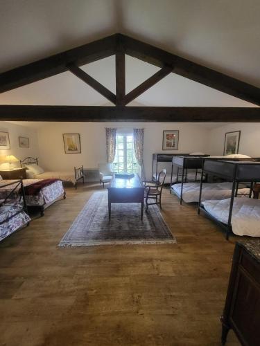 a large room with several beds and a couch at Domaine de Bertranet - Chambres D'Hôtes in Tonneins