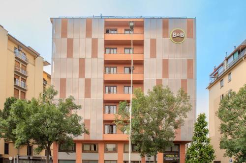 an external view of a building with trees in front at B&B Hotel Firenze Nuovo Palazzo Di Giustizia in Florence