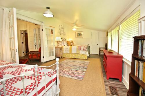 a bedroom with a bed and a couch at Frog Cottage on the Blanco in Wimberley