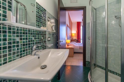 a bathroom with a sink and a shower at Hotel al ritrovo in Castelluzzo