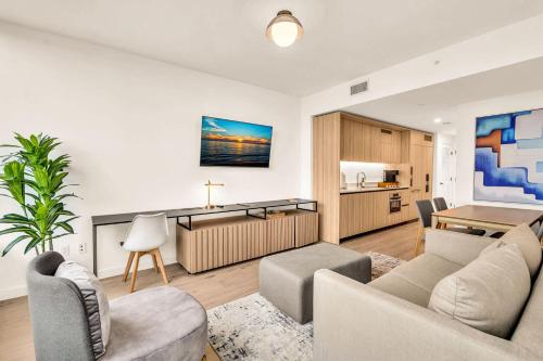 a living room with a couch and a table at Miami Oasis 2BR Apt Pool & Beach Access for 5 in Miami