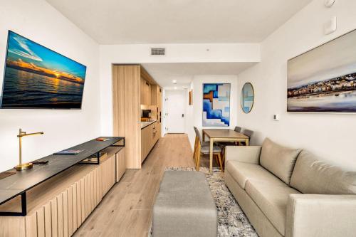 a living room with a couch and a table at Miami Oasis 2BR Apt Pool & Beach Access for 5 in Miami