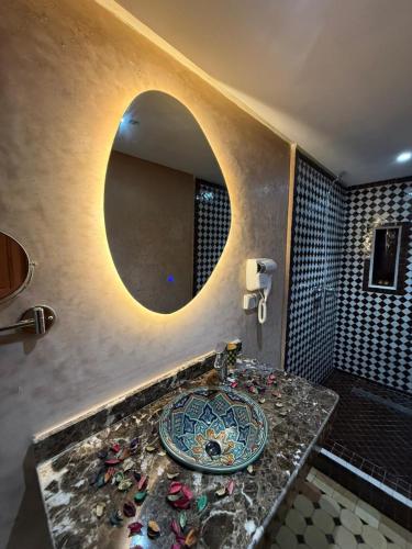 a bathroom with a sink and a mirror at Riad Mira in Fez