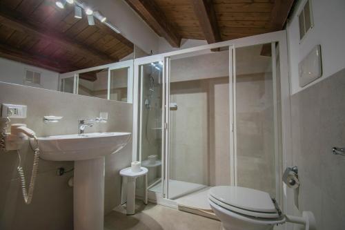 a bathroom with a shower and a toilet and a sink at Case Ruggero in Cefalù