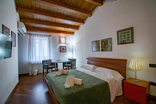 a bedroom with a bed and a desk and a table at Case Ruggero in Cefalù