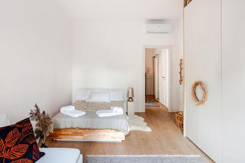 a bedroom with a bed with two towels on it at Suite and Home between Milano, Malpensa e Como Lake in Saronno