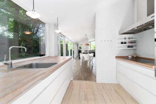 a kitchen with a sink and a large window at Spacious Luxury Villa Apartment - Two Bedrooms in Egå