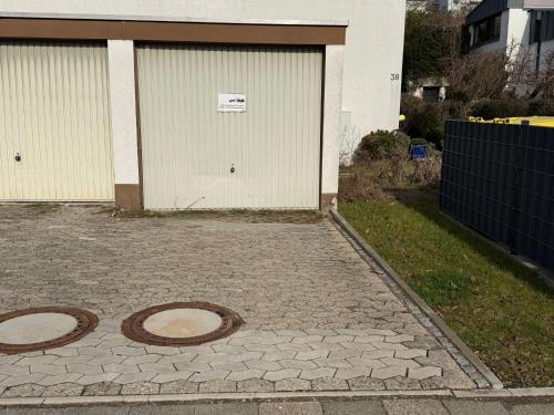 a driveway with two circles on the ground in front of a garage at Apartment Alex in Hildesheim