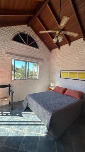 a bedroom with a bed and a ceiling fan at Complejo Pueblo del Sol in Piriápolis