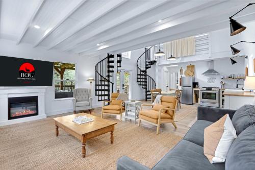 a living room with a couch and a fireplace at Good Day Treehouse in Wimberley