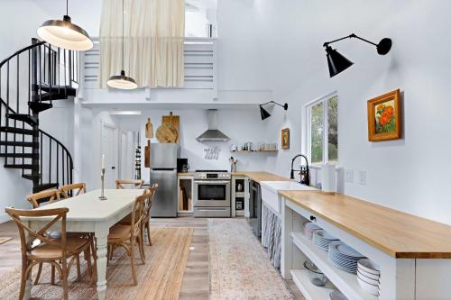 a kitchen and dining room with a table and chairs at Good Day Treehouse in Wimberley