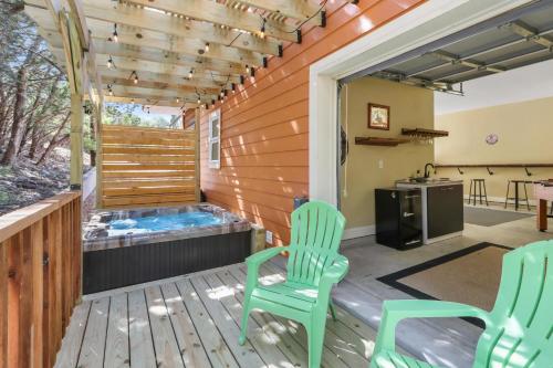 a patio with two chairs and a hot tub at Green Roof Cottage in Canyon Lake