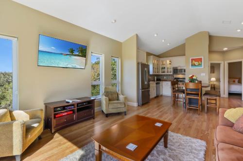 a living room with a couch and a table at Green Roof Cottage in Canyon Lake