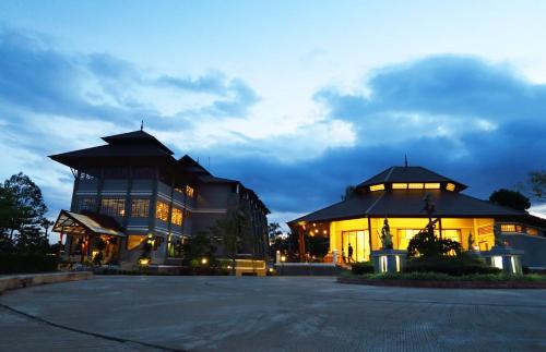 a large building with a statue in front of it at Phurua Sanctuary Resort and Spa in Phu Rua