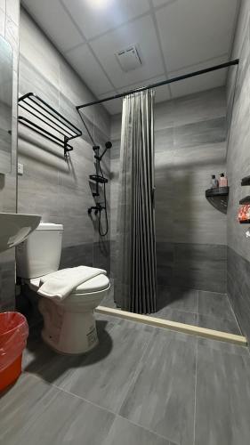 a bathroom with a toilet and a shower at 潔希民宿一館 in Hsin-chieh