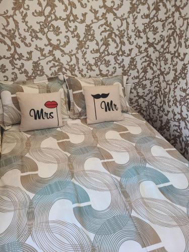 a bed with two pillows on top of it at Апартаменти в Центі Одеси in Odesa