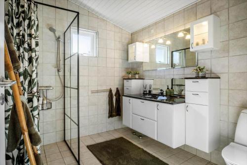 a bathroom with a shower and a sink and a toilet at BL1163-Blokhus-Raappenmark-2 in Blokhus