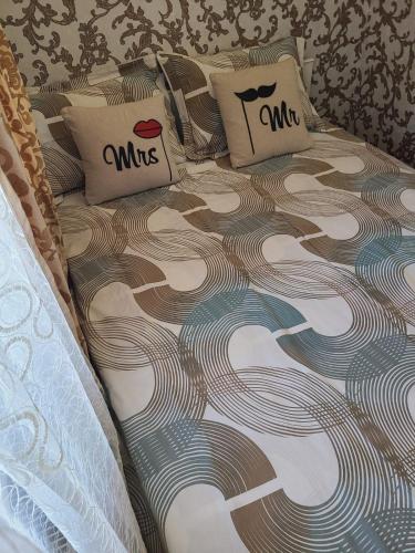a bed with two pillows on top of it at Апартаменти в Центі Одеси in Odesa
