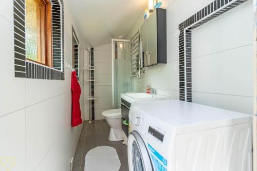 a bathroom with a washer and dryer in it at VGO922-Grabo-Strandkullen-22 in Gråbo
