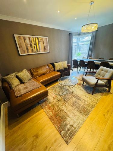 a living room with a couch and a table at Mayors House Ideal for Groups & Business in Peterborough