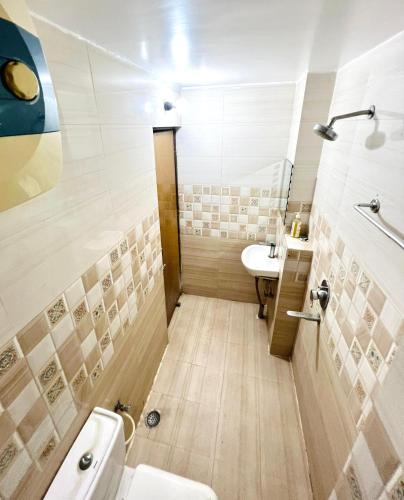 a bathroom with a toilet and a sink at Hotel Aman in Patna