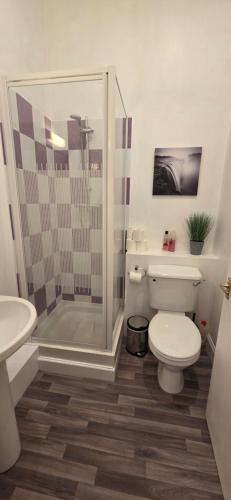 a bathroom with a toilet and a glass shower at Grindlay Street Residence, 2 Bedroom, 2 Bathroom apartment close to Castle in Edinburgh