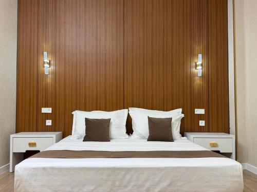 a bedroom with a large bed with white pillows at ART REGENCY Premium Hotel in Tashkent