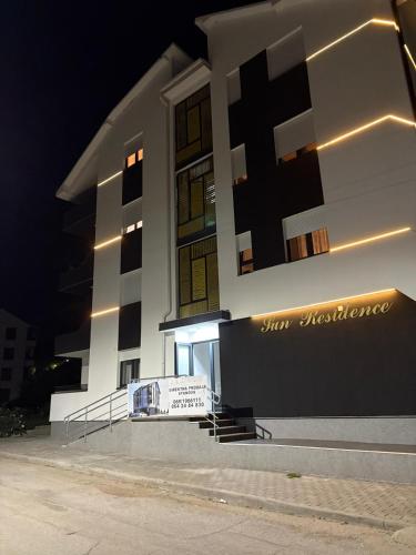a building with a sign in front of it at night at Apartman Iva in Soko Banja