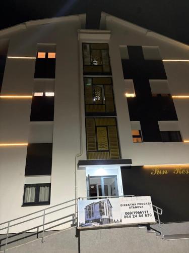 a building with a sign in front of it at Apartman Iva in Soko Banja