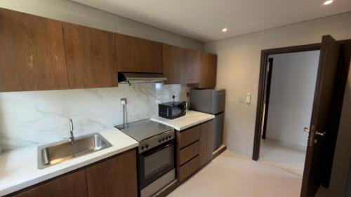 a kitchen with a sink and a stove at Hatta Residence in Hatta