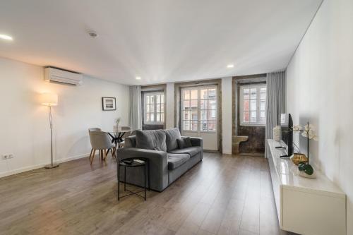 a living room with a couch and a table at PALHOTAS GUEST HOUSE - Apartamento Sameiro in Braga
