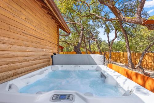 a hot tub in the backyard of a house at Happy Hideaway in Wimberley