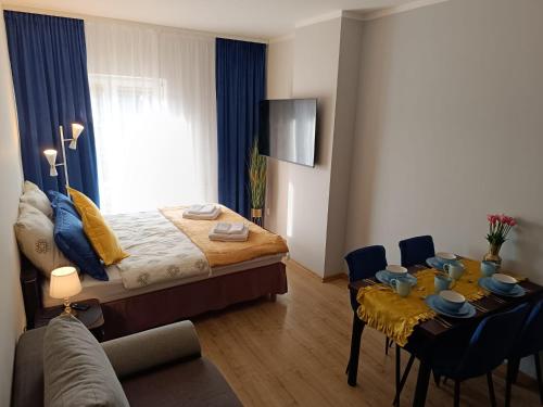 a bedroom with a bed and a table with chairs at JULA Pokoje Blisko Plaży, Dąbki in Dąbki