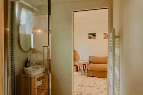 a bathroom with a mirror and a sink in a room at Palmito in Bidart