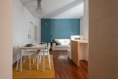 a dining room with a table and chairs and a couch at La Casetta di Gio in Busnago