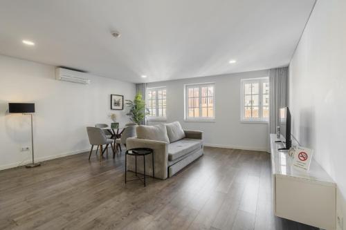 a living room with a couch and a table at PALHOTAS GUEST HOUSE - Apartamento Palhotas in Braga