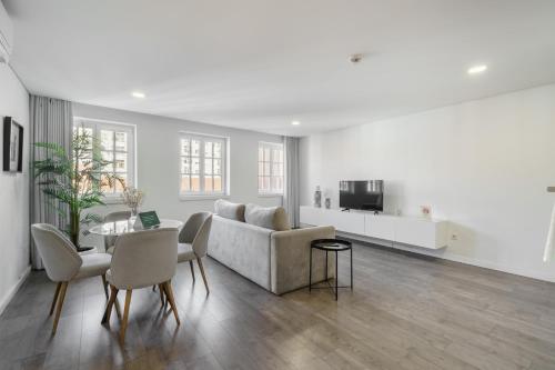 a living room with a couch and a table at PALHOTAS GUEST HOUSE - Apartamento Palhotas in Braga
