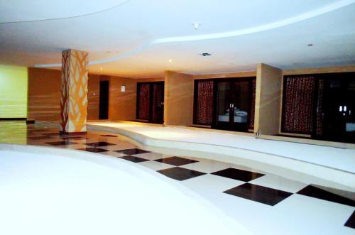 a hotel lobby with a black and white checkered floor at Nirmala Hotel & Convention Centre in Denpasar